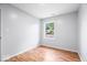 Bedroom with hardwood floors and a bright window overlooking the yard at 9526 Burrwood Ct, Indianapolis, IN 46235