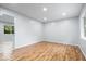 Spacious bedroom with hardwood floors, large window and neutral colored walls at 9526 Burrwood Ct, Indianapolis, IN 46235
