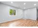 Bedroom with hardwood floors, a bright window and white doors at 9526 Burrwood Ct, Indianapolis, IN 46235