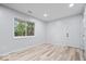 Bright bedroom with a neutral color palette, hardwood floors, and a large window at 9526 Burrwood Ct, Indianapolis, IN 46235