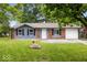 Charming home with lush front lawn, brick accents, and vinyl siding at 9526 Burrwood Ct, Indianapolis, IN 46235