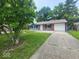 Inviting one-story home featuring a well-maintained lawn and a paved driveway leading to the garage at 9526 Burrwood Ct, Indianapolis, IN 46235