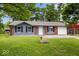 Charming home with lush front lawn, brick accents, and vinyl siding at 9526 Burrwood Ct, Indianapolis, IN 46235