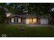 Charming single story home with brick and gray siding, attached garage and a green lawn at 9526 Burrwood Ct, Indianapolis, IN 46235