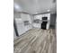 Well-lit kitchen with white cabinets, stainless steel appliances, and sleek granite countertops at 9526 Burrwood Ct, Indianapolis, IN 46235