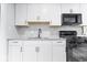 Updated kitchen features white cabinets, granite counters, tiled backsplash and stainless steel appliances at 9526 Burrwood Ct, Indianapolis, IN 46235