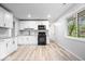 Modern kitchen featuring white cabinets, stainless steel appliances, and hardwood floors at 9526 Burrwood Ct, Indianapolis, IN 46235