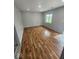 Bright living room with hardwood flooring, neutral walls, and natural light from a large window at 9526 Burrwood Ct, Indianapolis, IN 46235