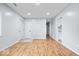 Open-concept living room featuring hardwood floors and white walls at 9526 Burrwood Ct, Indianapolis, IN 46235