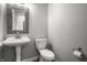 Elegant powder room features a pedestal sink, decorative mirror, and modern toilet at 9678 Winter Way, Zionsville, IN 46077