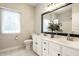 Bright bathroom featuring double vanity, modern fixtures, a decorative house plant, and a large mirror at 9678 Winter Way, Zionsville, IN 46077
