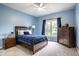 Bright bedroom with blue walls, white carpet, ceiling fan, and wood furniture at 9678 Winter Way, Zionsville, IN 46077