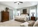 Bright bedroom with tray ceiling, sliding glass doors to the yard, and neutral decor at 9678 Winter Way, Zionsville, IN 46077