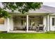 The backyard features a covered patio with an outdoor dining area and barbecue grill at 9678 Winter Way, Zionsville, IN 46077