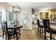 Open dining area with a view to the kitchen and living room with hardwood flooring and natural light at 9678 Winter Way, Zionsville, IN 46077