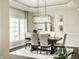 Inviting dining room with hardwood flooring, statement lighting, and comfortable seating at 9678 Winter Way, Zionsville, IN 46077