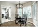 Cozy dining area with modern lighting, natural light, and hardwood floors at 9678 Winter Way, Zionsville, IN 46077