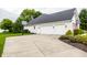 Exterior elevation of a white brick house with garage, driveway, and basketball hoop at 9678 Winter Way, Zionsville, IN 46077