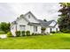 Classic brick home boasting a well-maintained lawn, complemented by flowering bushes and greenery at 9678 Winter Way, Zionsville, IN 46077