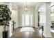 Bright foyer showcases hardwood floors, decorative lighting, and an open entry to main living spaces at 9678 Winter Way, Zionsville, IN 46077