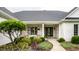 Welcoming front porch with seating area, framed by elegant columns and meticulous landscaping at 9678 Winter Way, Zionsville, IN 46077