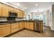 Well-appointed kitchen with stainless steel appliances, granite countertops, and wood flooring at 9678 Winter Way, Zionsville, IN 46077