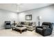 Cozy living room features plush seating, stylish decor, and a ceiling fan for added comfort at 9678 Winter Way, Zionsville, IN 46077