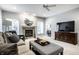Comfortable living room with a cozy fireplace, large TV, and soft carpeting at 9678 Winter Way, Zionsville, IN 46077