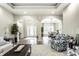 Spacious living room with elegant columns, hardwood floors, stylish furniture, and abundant natural light at 9678 Winter Way, Zionsville, IN 46077