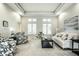 Inviting living room featuring tray ceilings, large windows, and comfortable seating at 9678 Winter Way, Zionsville, IN 46077