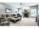 Inviting living room with a fireplace, comfortable seating, and soft carpeting at 9678 Winter Way, Zionsville, IN 46077