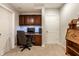 Home office with built in wood desk, storage and white door at 9678 Winter Way, Zionsville, IN 46077