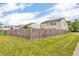 A large green backyard surrounded by a wooden fence at 10187 Yosemite Ln, Indianapolis, IN 46234