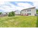 A spacious backyard with a wooden fence surrounding the area and homes in the background at 10187 Yosemite Ln, Indianapolis, IN 46234