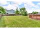Spacious, green backyard with a wooden fence and deck at 10187 Yosemite Ln, Indianapolis, IN 46234