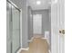 Bathroom showcasing a tiled floor, glass enclosed shower, and access to the walk-in closet at 10187 Yosemite Ln, Indianapolis, IN 46234