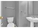Small bathroom features a toilet, sink, mirror, and towel rack at 10187 Yosemite Ln, Indianapolis, IN 46234