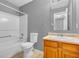 Bathroom boasts a tub/shower combo and a wooden vanity with ample storage at 10187 Yosemite Ln, Indianapolis, IN 46234