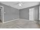 Cozy bedroom featuring neutral carpeting and a ceiling fan at 10187 Yosemite Ln, Indianapolis, IN 46234