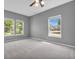 The bedroom offers plenty of natural light with three large windows and neutral gray walls at 10187 Yosemite Ln, Indianapolis, IN 46234