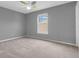 Bright bedroom with neutral carpet and large window at 10187 Yosemite Ln, Indianapolis, IN 46234