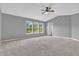 Spacious bedroom boasts three windows for natural light, vaulted ceiling, and neutral carpeting at 10187 Yosemite Ln, Indianapolis, IN 46234