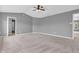 Spacious bedroom with neutral carpeting, ceiling fan, and ensuite bathroom access at 10187 Yosemite Ln, Indianapolis, IN 46234