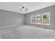 Light filled bedroom with neutral walls, carpeted floors, and a ceiling fan at 10187 Yosemite Ln, Indianapolis, IN 46234