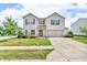 Charming two-story home featuring red shutters, a well-maintained lawn, and a classic suburban appeal at 10187 Yosemite Ln, Indianapolis, IN 46234