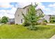 Side view of a two-story home with mature landscaping and a green lawn at 10187 Yosemite Ln, Indianapolis, IN 46234