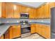 A well-equipped kitchen features wood cabinets, stainless steel appliances, and sleek countertops at 10187 Yosemite Ln, Indianapolis, IN 46234