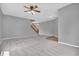 Spacious living room featuring carpet, a staircase, and a ceiling fan at 10187 Yosemite Ln, Indianapolis, IN 46234