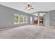 Spacious living room featuring soft carpet, natural light, and easy access to the kitchen at 10187 Yosemite Ln, Indianapolis, IN 46234