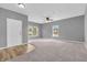 Bright and spacious living room with plush carpet, neutral walls, and abundant natural light at 10187 Yosemite Ln, Indianapolis, IN 46234